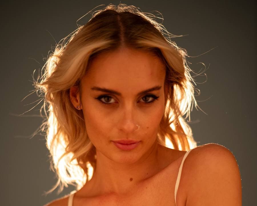 Close portrait in warm, golden light.